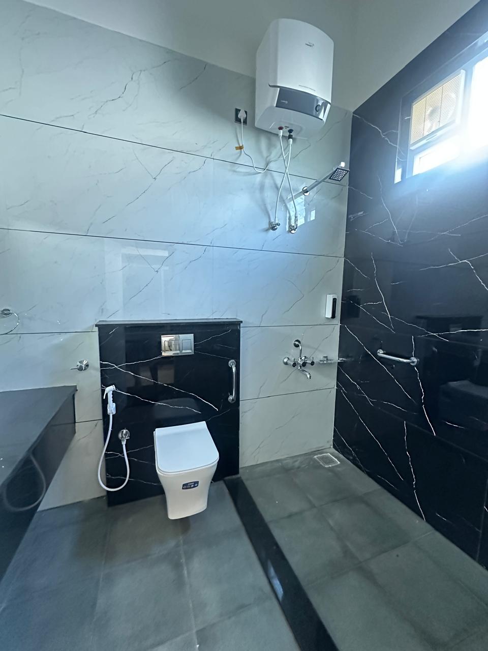 Marble bathroom with rain shower and geyser