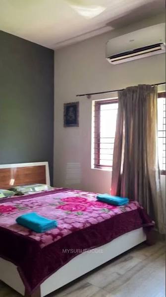 Air-conditioned bedroom with warm interiors and garden window