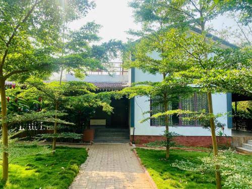Villa entrance pathway with landscaped trees and gardens