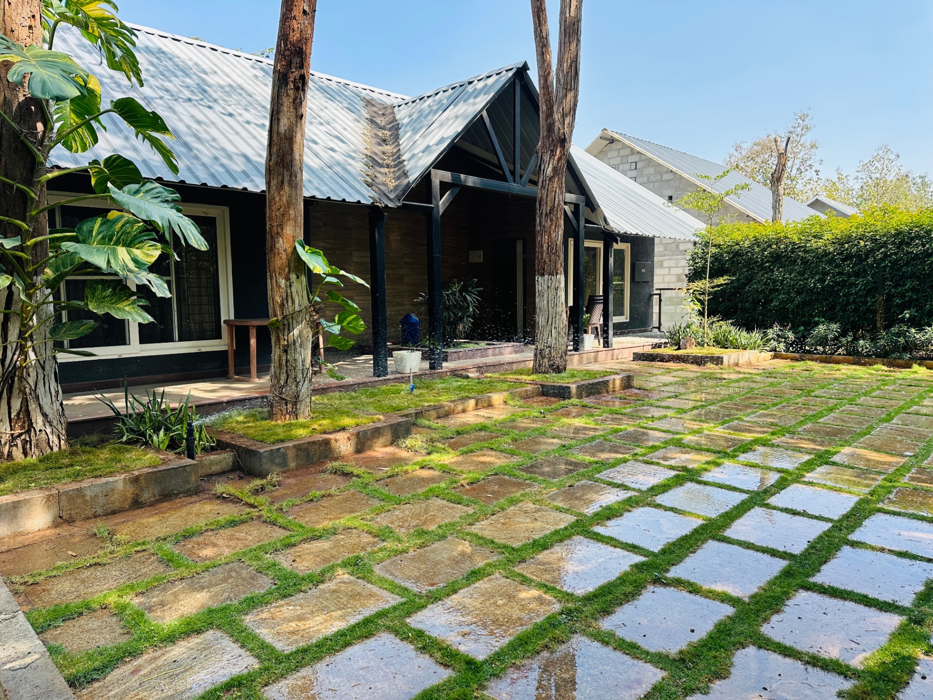 Cottage exterior with chess-patterned flagstone lawn and gabled roof